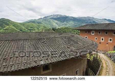Roofs of Tulou buildings in a village from Hakka minority group were built eight centuries ago; Yongding, Fujian province, China View Large Photo Image Stock Photography - Roofs of Tulou buildings in a village from Hakka minority group were built eight centuries ago; Yongding, Fujian province, China. Fotosearch