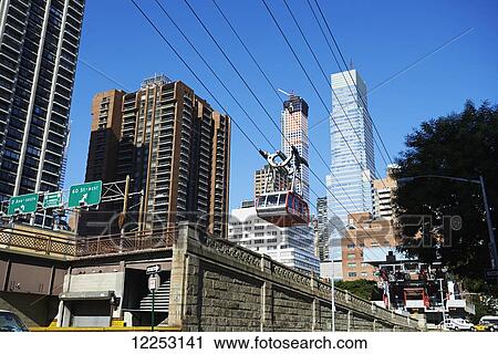 Stock Image - Roosevelt Island tram leaving Manhattan; New York City, New York, United States of America. Fotosearch