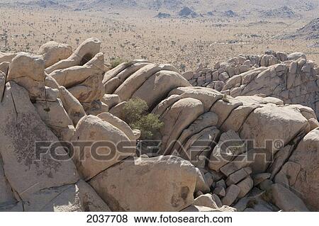 Stock Photo - Rounded Rock Formations With Desert Valley In The Distance; Palm Springs California United States Of America. Fotosearch