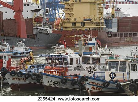 Row Of Colourful Fishing Boats In The Foreground With Shipping Boats In The Background; Valparaiso, Chile View Large Photo Image Picture - Row Of Colourful Fishing Boats In The Foreground With Shipping Boats In The Background; Valparaiso, Chile. Fotosearch