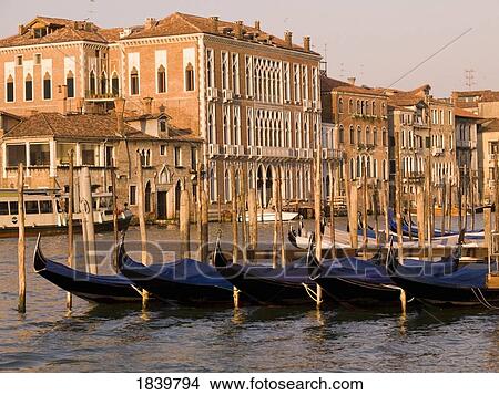 Row Of Gondolas, Buildings In Background; Venice, Italy View Large Photo Image Picture - Row Of Gondolas, Buildings In Background; Venice, Italy. Fotosearch