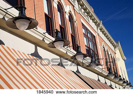 Stock Image - Row Of Lamps Above Awning; Calgary, Alberta, Canada. Fotosearch