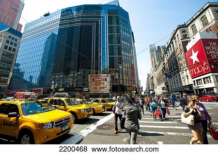 Stock Photo - Row Of Ny Taxis And Pedestrians Crossing The Street In Front Of Macy's, The Biggest Department Store In The World, Manhattan, New York, Usa. Fotosearch