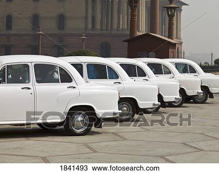Stock Image - Row Of White Cars; Delhi, India. Fotosearch