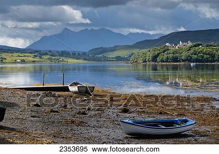 Rowboats on the shore along the edge of a lake; Cuillins, Isle of Skye, Scotland View Large Photo Image Stock Photography - Rowboats on the shore along the edge of a lake; Cuillins, Isle of Skye, Scotland. Fotosearch