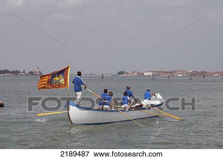 Rowers In A Boat With Venetian Flag With Venice In The Background, Veneto Region, Italy View Large Photo Image Stock Photo - Rowers In A Boat With Venetian Flag With Venice In The Background, Veneto Region, Italy. Fotosearch