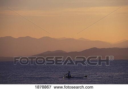 Stock Photo - Rowing Early Morning In The Bay. Fotosearch