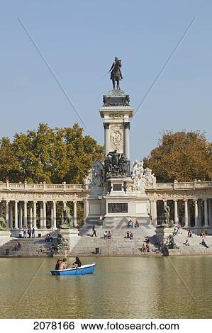 Rowing On The Lake In El Retiro Gardens With The Monument To King Alfonso Xii In Background; Madrid Spain View Large Photo Image Stock Photograph - Rowing On The Lake In El Retiro Gardens With The Monument To King Alfonso Xii In Background; Madrid Spain. Fotosearch