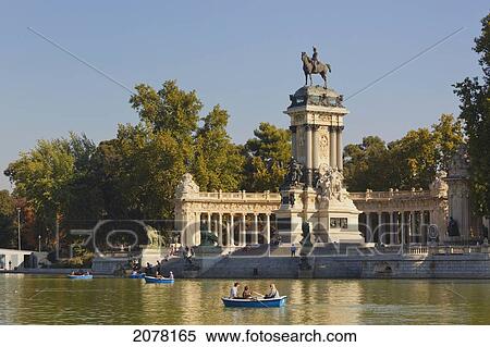 Rowing On The Lake In El Retiro Gardens With The Monument To King Alfonso Xii In Background; Madrid Spain View Large Photo Image Stock Photography - Rowing On The Lake In El Retiro Gardens With The Monument To King Alfonso Xii In Background; Madrid Spain. Fotosearch