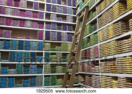Stock Photography - Rows of shelves with colourful textiles arranged by colour and shade; Fez, Morocco. Fotosearch