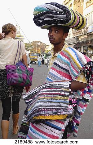 Rug Seller With Carpets Draped Over His Body In Mysore, Karnataka, India View Large Photo Image Stock Photo - Rug Seller With Carpets Draped Over His Body In Mysore, Karnataka, India. Fotosearch
