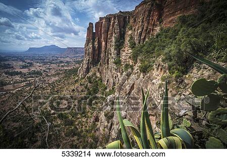 Rugged cliffs and plants on a landscape; Tigray, Ethiopia View Large Photo Image Picture - Rugged cliffs and plants on a landscape; Tigray, Ethiopia. Fotosearch
