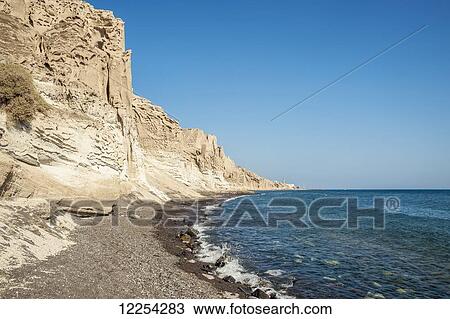 Stock Image - Rugged coastline; Santorini, Greece. Fotosearch