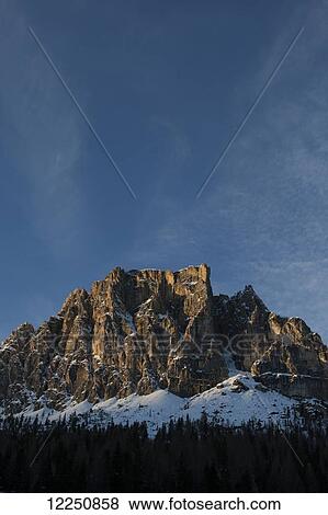 Stock Photo - Rugged mountain peak against blue sky; Cortina d'Ampezzo, Italy. Fotosearch