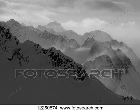 Picture - Rugged peaks of a mountain range under clouds; Haines, Alaska, United States of America. Fotosearch
