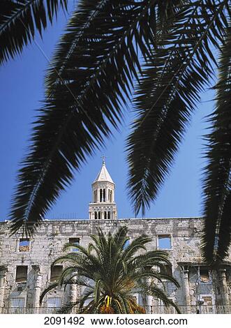 Stock Image - Ruined Facade Of Building On Riva And The Campanile Of The Cathedral Of St. Domnius, Diocletian's Palace, Split, Croatia.. Fotosearch