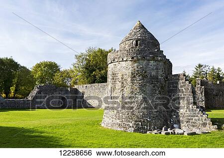 Stock Photograph - Ruins of a stone castle with stone wall and blue sky; County Galway, Ireland. Fotosearch
