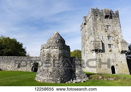 Stock Photography - Ruins of a stone castle with stone wall and blue sky; County Galway, Ireland. Fotosearch