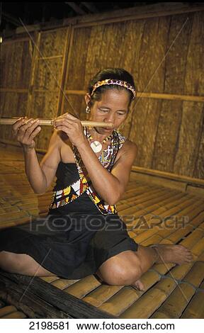 Runggus Woman Playing Nose Flute In A Long House, Sabah, Borneo, Malaysia View Large Photo Image Stock Image - Runggus Woman Playing Nose Flute In A Long House, Sabah, Borneo, Malaysia. Fotosearch