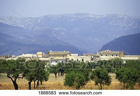Stock Image - Rural Village At The Base Of Mountains. Fotosearch