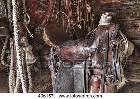 Stock Image - Saddle and horseback riding equipment at Bar U Ranch National Historic Site; Longview, Alberta, Canada. Fotosearch
