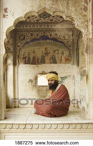 Stock Photography - Sadhu With Beard And Turban Sitting Under Archway. Fotosearch