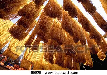 Stock Image - Safron Dyed Cloth Hanging Up To Dry In Souks Of Marrakesh, Morocco. Fotosearch