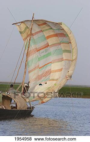 Stock Photo - Sail boat on Lake Debo, formed by the seasonal flooding of the Niger River, Mali. Fotosearch