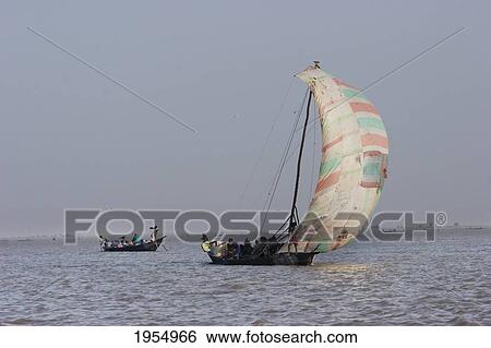 Stock Photograph - Sail boat on Lake Debo, formed by the seasonal flooding of the Niger River, Mali. Fotosearch