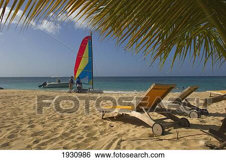 Sailboat And Deck Chairs On The Sands Of Magazine Beach; Carriacou Island, Grenada View Large Photo Image Stock Photograph - Sailboat And Deck Chairs On The Sands Of Magazine Beach; Carriacou Island, Grenada. Fotosearch