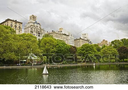 Stock Image - Sailboat In Central Park Pond; New York City New York Usa. Fotosearch