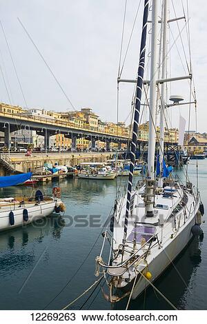 Stock Image - Sailboat moored in harbour; Genoa, Liguria, Italy. Fotosearch