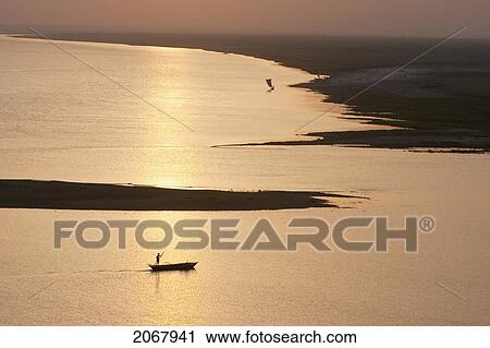 Sailboat On The Ganges River At Sunset, Patna, Bihar, India View Large Photo Image Stock Image - Sailboat On The Ganges River At Sunset, Patna, Bihar, India. Fotosearch