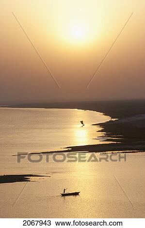 Stock Image - Sailboat On The Ganges River At Sunset, Patna, Bihar, India. Fotosearch