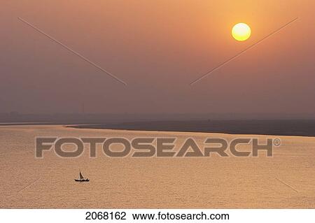 Sailboat On The Ganges River At Sunset, Patna, Bihar, India View Large Photo Image Stock Image - Sailboat On The Ganges River At Sunset, Patna, Bihar, India. Fotosearch