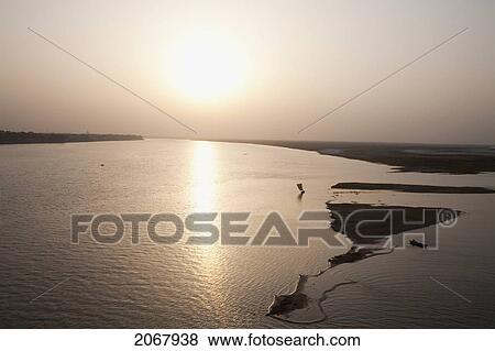 Stock Photo - Sailboat On The Ganges River At Sunset, Patna, Bihar, India. Fotosearch