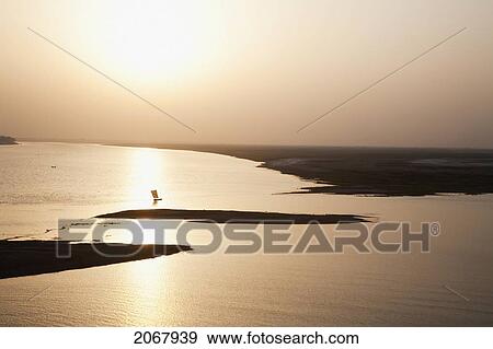 Stock Photo - Sailboat On The Ganges River At Sunset, Patna, Bihar, India. Fotosearch