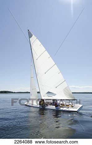 Sailboat With Crew Sailing On A Lake; Kenora Ontario Canada View Large Photo Image Stock Photo - Sailboat With Crew Sailing On A Lake; Kenora Ontario Canada. Fotosearch
