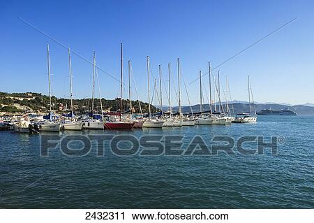 Stock Image - Sailboats in the harbour; Porto Venere, Liguria, Italy. Fotosearch
