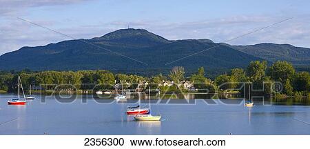 Stock Image - Sailboats On Lac Memphremagog With Mont Orford In Background; Magog, Quebec, Canada. Fotosearch