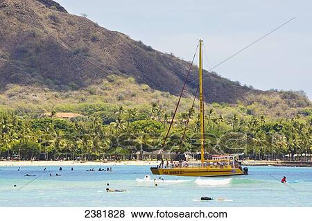 Stock Photo - Sailing and swimming in a bay; Honolulu, Ohau, Hawaii, United States of America. Fotosearch