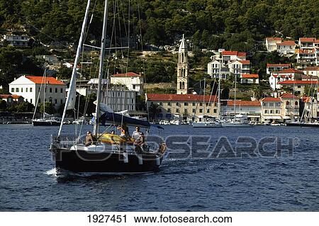 Stock Image - Sailing Into Afternoon Sun From The Island Of Hvar; Hvar, Split-Dalmatia County, Croatia. Fotosearch