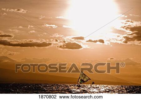 Stock Image - Sailing On The Ocean At Sunset. Fotosearch