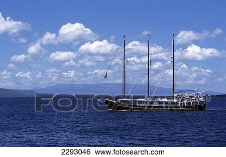 Stock Photograph - Sailing Ship With Tall Masts On Ocean, Punta Espinosa, Fernandina, Ecuador, Galapagos Islands.. Fotosearch
