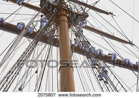 Stock Photo - Sailors Climbing A Rig Of The Four-Mast Barquentine, Chilean Navy Training Ship Esmeralda In Hanga Roa Harbour, Rapa Nui (Easter Island), Chile. Fotosearch