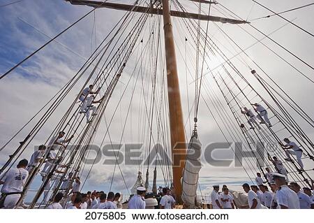 Stock Photography - Sailors Climbing A Rig Of The Four-Mast Barquentine, Chilean Navy Training Ship Esmeralda In Hanga Roa Harbour, Rapa Nui (Easter Island), Chile. Fotosearch