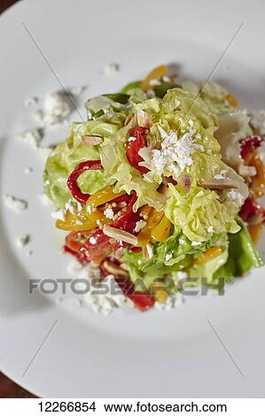 Picture - Salad with Boston lettuce, red pepper, goat cheese, cashew nuts, and orange slices; Ontario, Canada. Fotosearch