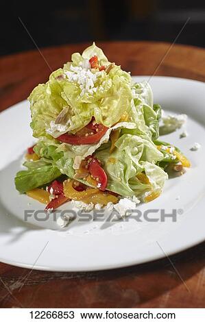 Stock Image - Salad with Boston lettuce, red pepper, goat cheese, cashew nuts, and orange slices; Ontario, Canada. Fotosearch