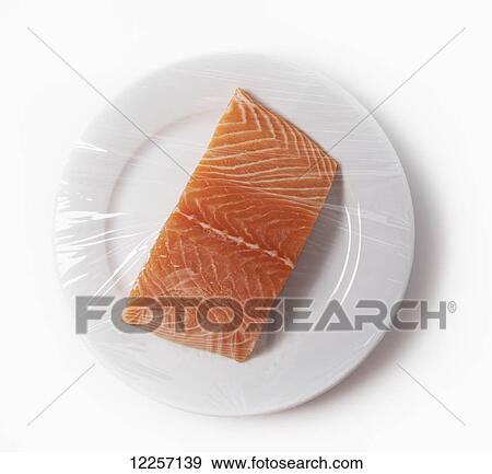 Salmon on a plate with plastic wrap View Large Photo Image Stock Photo - Salmon on a plate with plastic wrap. Fotosearch