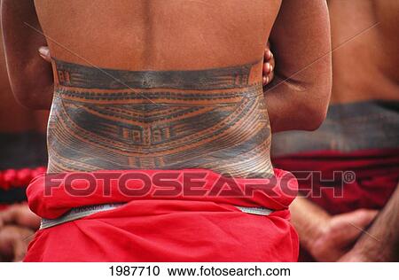 Stock Image - Samoa, Closeup Of A Tattoo On A Local Mans Back As He Stands Wearing Traditional Lavalava.. Fotosearch